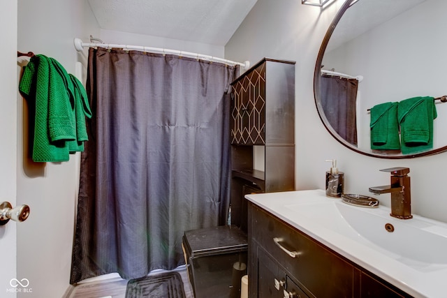 bathroom with vanity, a textured ceiling, and a shower with shower curtain