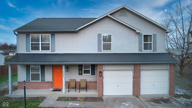 view of front of home with a porch and a garage