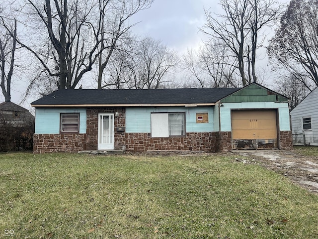 single story home featuring a front yard and a garage