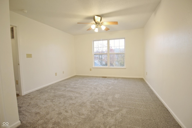 carpeted empty room featuring ceiling fan