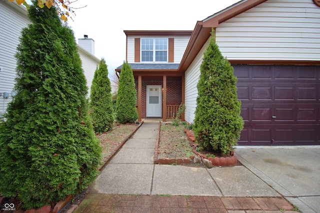 view of exterior entry featuring a garage