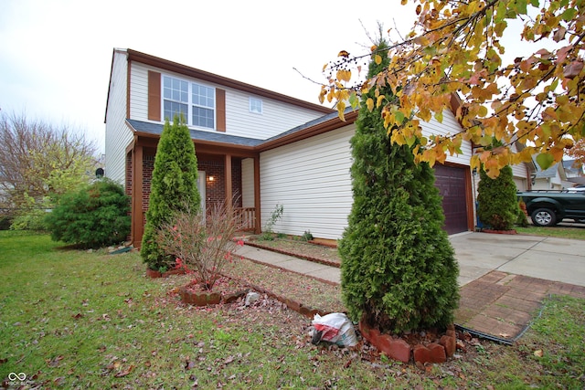 view of front of house featuring a front yard and a garage