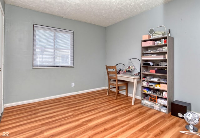 office space with hardwood / wood-style floors and a textured ceiling