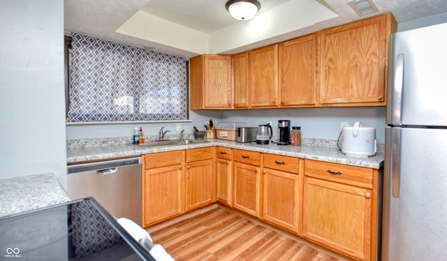 kitchen featuring light hardwood / wood-style floors, sink, and appliances with stainless steel finishes