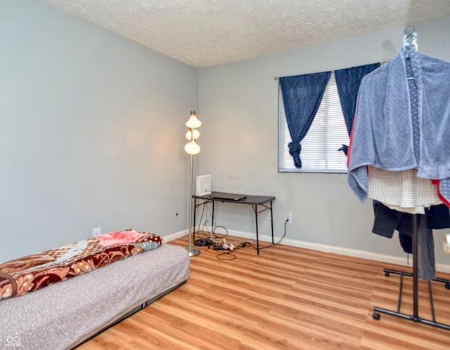 sitting room with hardwood / wood-style flooring and a textured ceiling