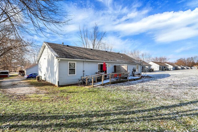 back of property with central air condition unit and a wooden deck