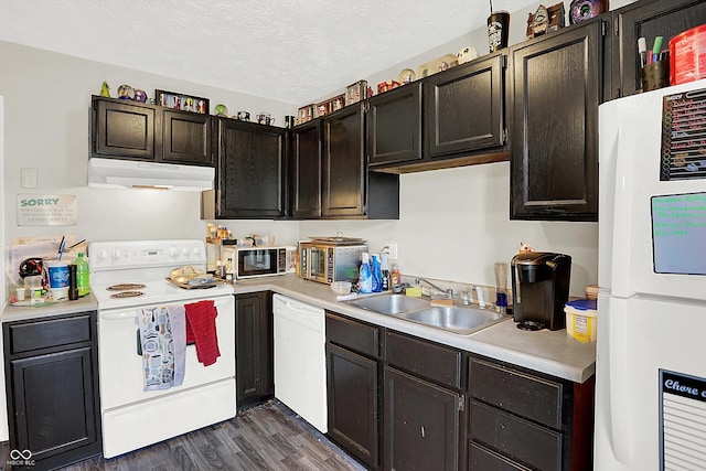 kitchen with a textured ceiling, white appliances, dark brown cabinetry, dark wood-type flooring, and sink