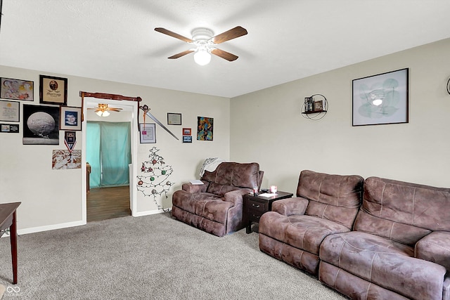 carpeted living room with ceiling fan