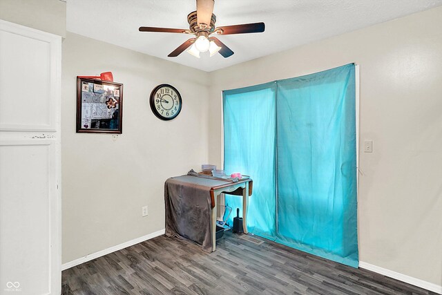 interior space with dark hardwood / wood-style floors and ceiling fan