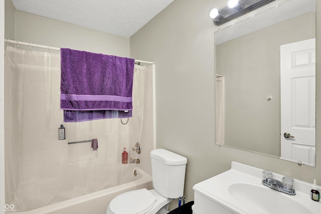 full bathroom featuring shower / bath combo with shower curtain, vanity, a textured ceiling, and toilet