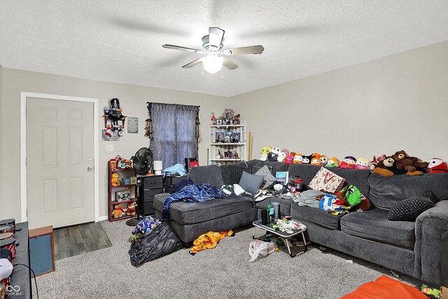 carpeted living room featuring ceiling fan and a textured ceiling