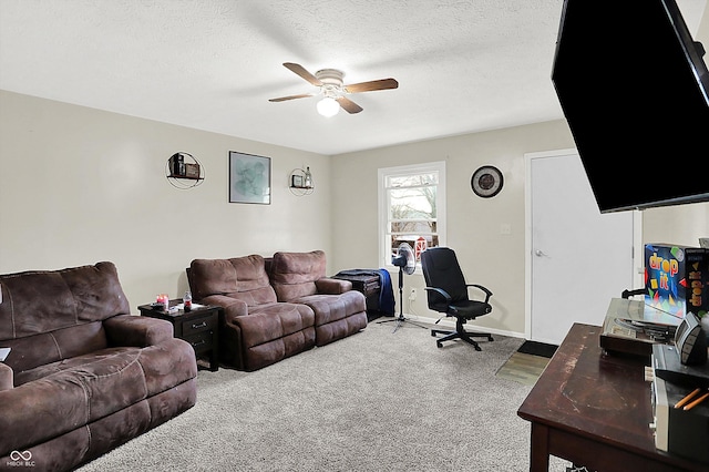 living room with ceiling fan, carpet floors, and a textured ceiling