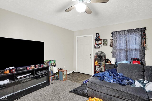 carpeted living room with a textured ceiling and ceiling fan