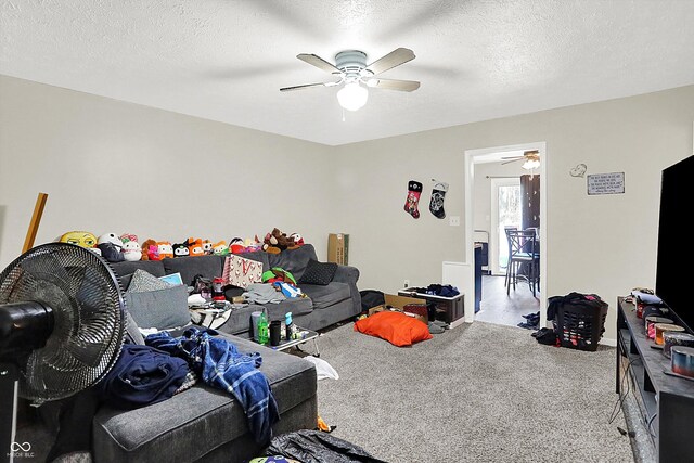 carpeted living room with a textured ceiling and ceiling fan