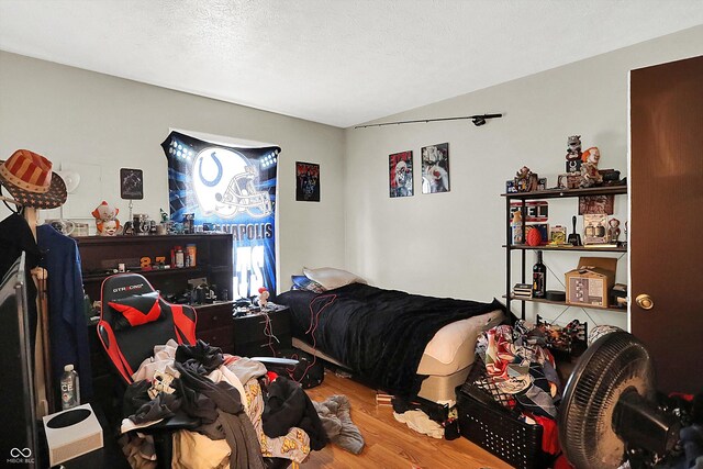 bedroom featuring hardwood / wood-style floors and a textured ceiling