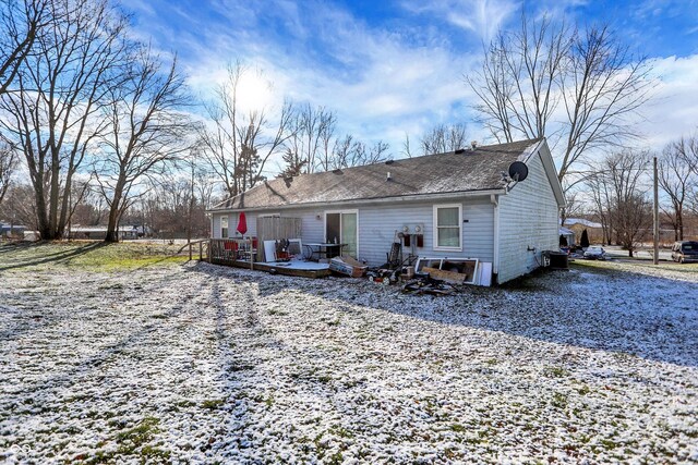 view of snow covered back of property