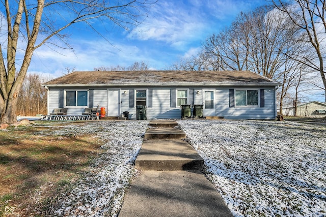 view of snow covered rear of property