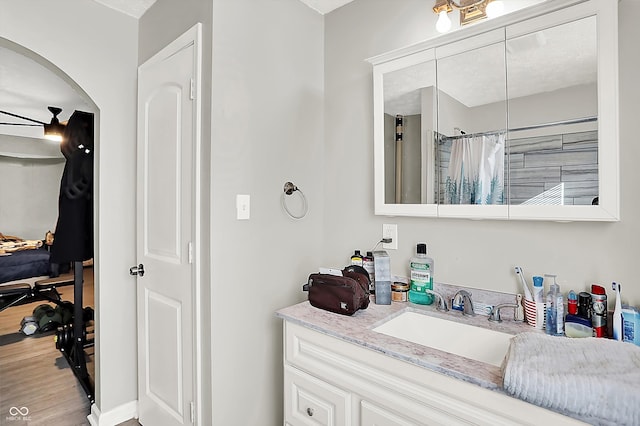 bathroom with a shower with shower curtain, vanity, and hardwood / wood-style flooring