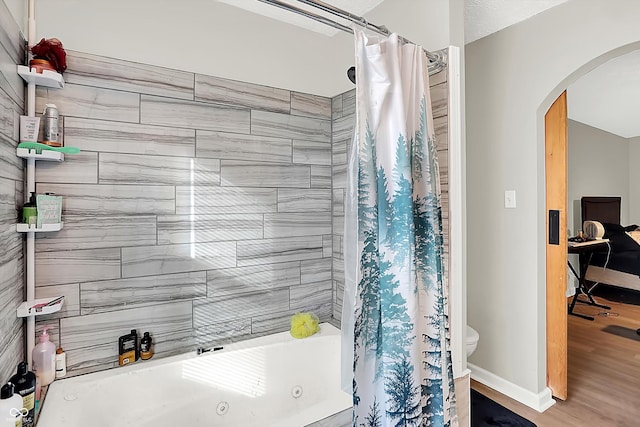 bathroom with shower / bath combination with curtain, hardwood / wood-style flooring, and toilet