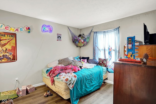 bedroom with hardwood / wood-style flooring