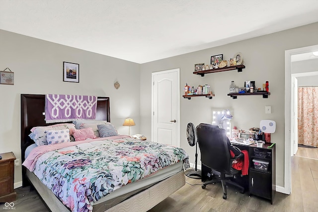 bedroom with wood-type flooring