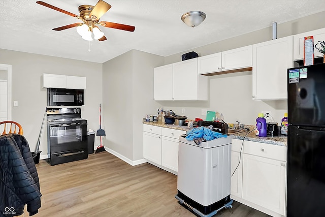 kitchen featuring white cabinets, light hardwood / wood-style flooring, ceiling fan, and black appliances