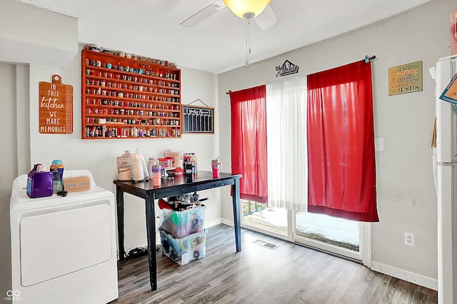 office space with hardwood / wood-style flooring, ceiling fan, and washer / dryer