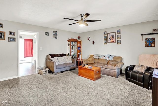 carpeted living room with ceiling fan