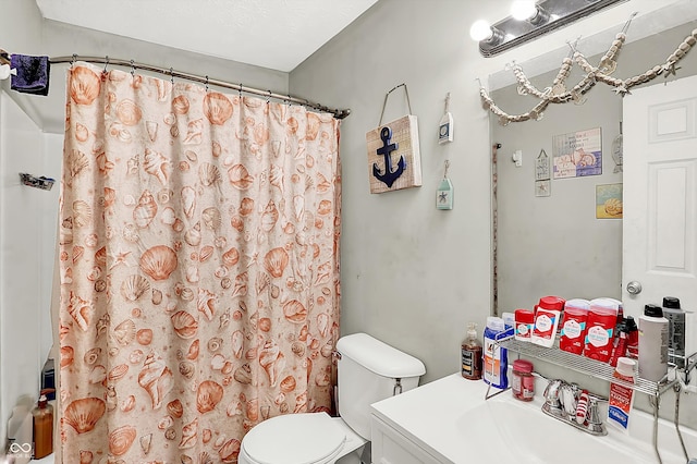 bathroom featuring a shower with shower curtain, vanity, and toilet