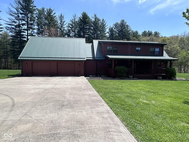 9695 S Houston Rd, Freetown, IN 47235 - view of front of house with a garage, driveway, and a front lawn