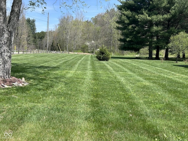 9695 S Houston Rd, Freetown, IN 47235 - view of yard featuring a view of trees and fence