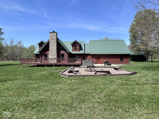 9695 S Houston Rd, Freetown, IN 47235 - rear view of house with a lawn, a deck, a chimney, and metal roof