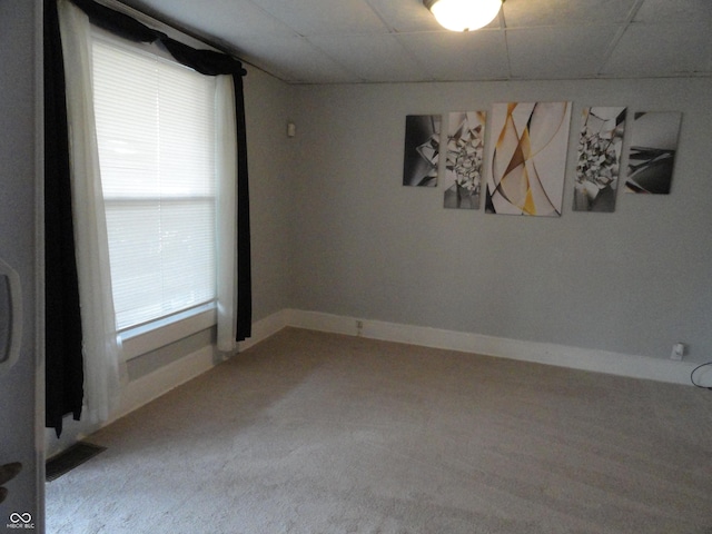 unfurnished room featuring a drop ceiling and carpet floors