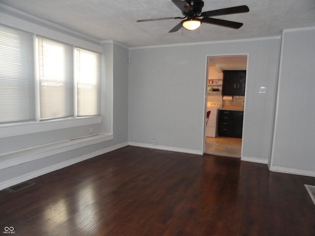 spare room featuring dark hardwood / wood-style floors, ceiling fan, and crown molding