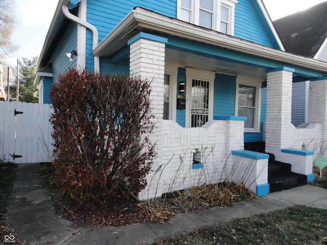 view of property exterior with covered porch