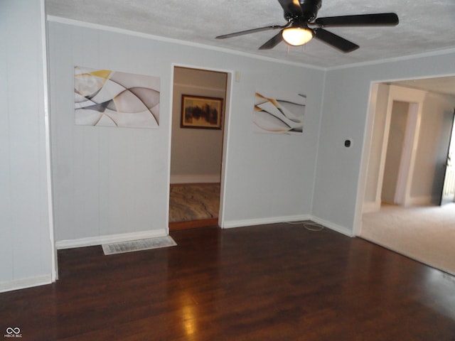 spare room with a textured ceiling, dark hardwood / wood-style flooring, and ceiling fan