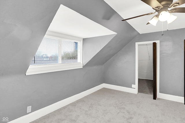 bonus room featuring vaulted ceiling, light colored carpet, and ceiling fan