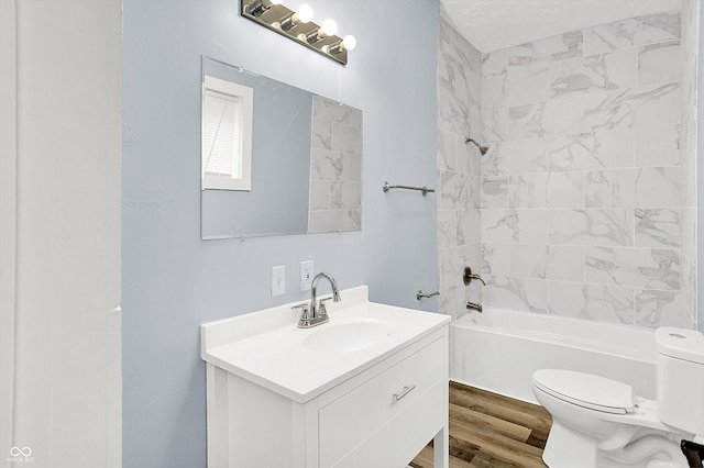 full bathroom with vanity, toilet, hardwood / wood-style floors, and tiled shower / bath