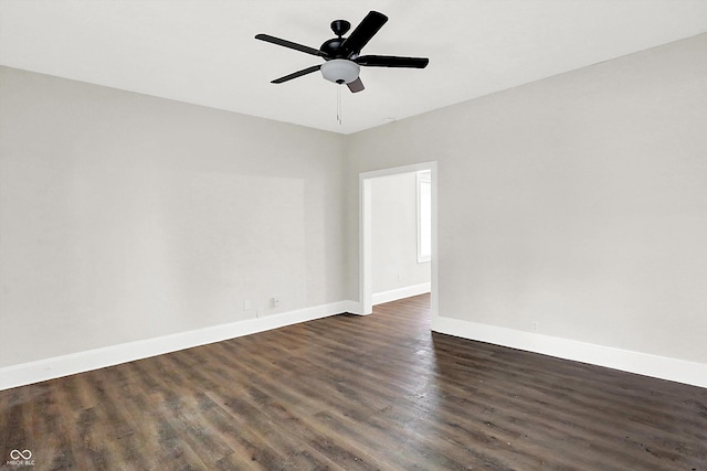 empty room featuring ceiling fan and dark hardwood / wood-style flooring