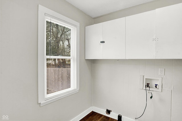 washroom with cabinets, dark hardwood / wood-style floors, and hookup for a washing machine