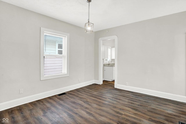 unfurnished room with sink and dark hardwood / wood-style flooring