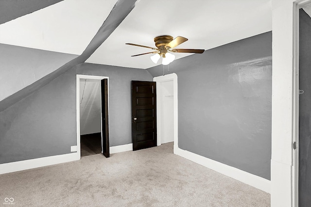 additional living space featuring light carpet, lofted ceiling, and ceiling fan