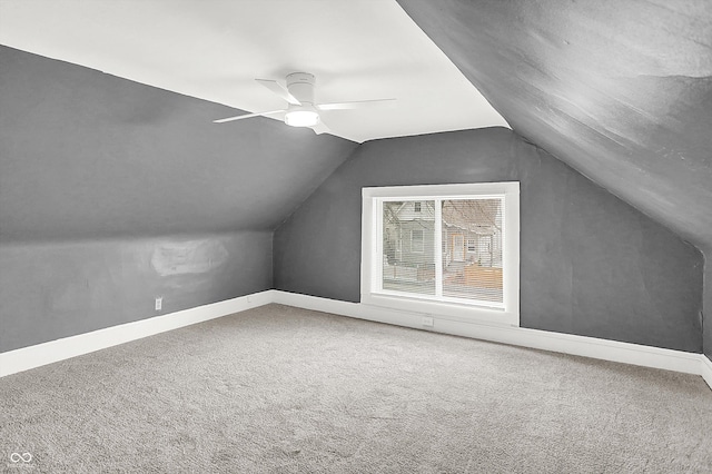 additional living space featuring vaulted ceiling, carpet floors, and ceiling fan