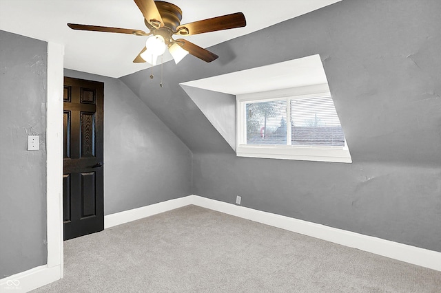 additional living space with lofted ceiling, light carpet, and ceiling fan