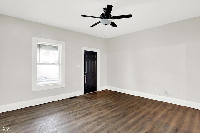 spare room with ceiling fan and dark hardwood / wood-style flooring