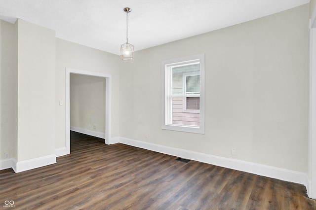 empty room with dark wood-type flooring