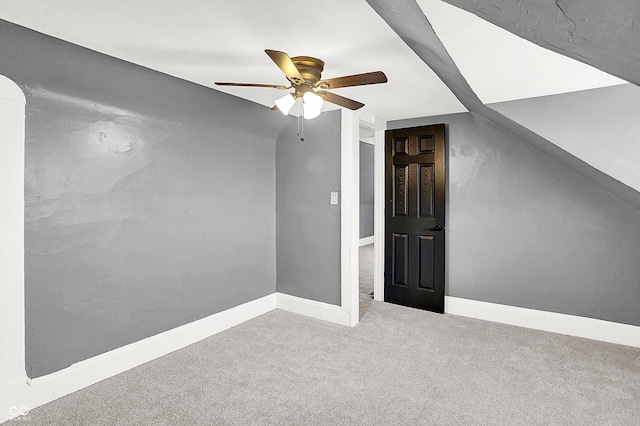 additional living space with ceiling fan, carpet flooring, and vaulted ceiling