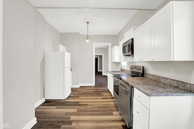 kitchen with sink, dark hardwood / wood-style floors, pendant lighting, stainless steel appliances, and white cabinets