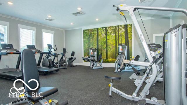 workout area featuring ornamental molding