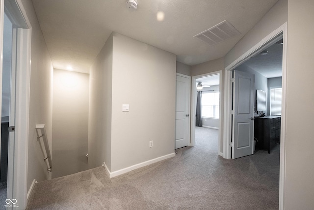 corridor with carpet flooring